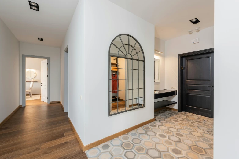 a hallway with a large mirror on the wall, inspired by Albert Paris Gütersloh, unsplash, located in hajibektash complex, listing image, apartment, an archway