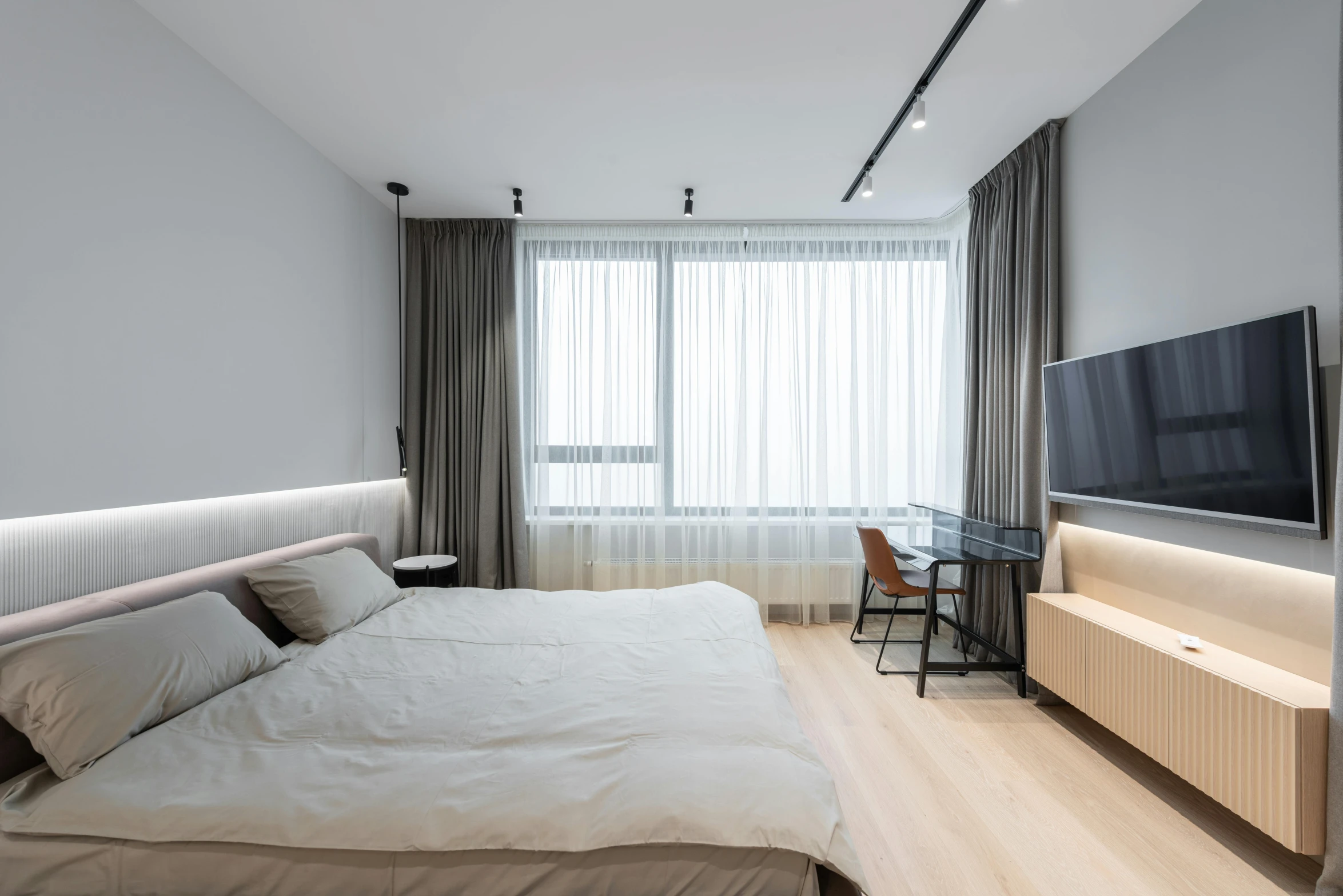 a bed room with a neatly made bed and a flat screen tv, by Adam Marczyński, light and space, grey, thumbnail, floor to ceiling window, scandinavian