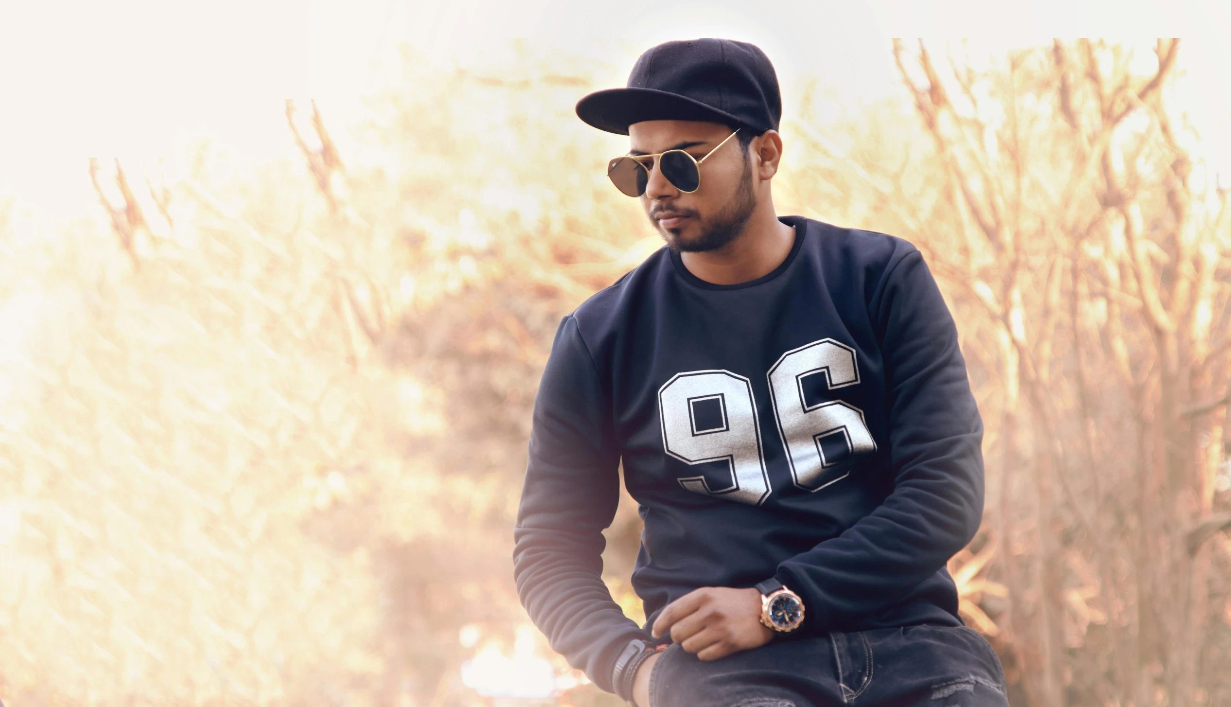 a man riding on the back of a horse, inspired by Manjit Bawa, pexels contest winner, realism, wearing sunglasses and a cap, wearing a black sweater, fashion pose, 9 9 designs