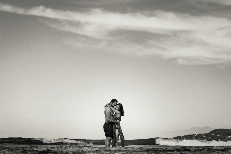 a black and white photo of a couple kissing on the beach, a black and white photo, by Kristian Zahrtmann, maui, mixed art, artem chebokha, skies