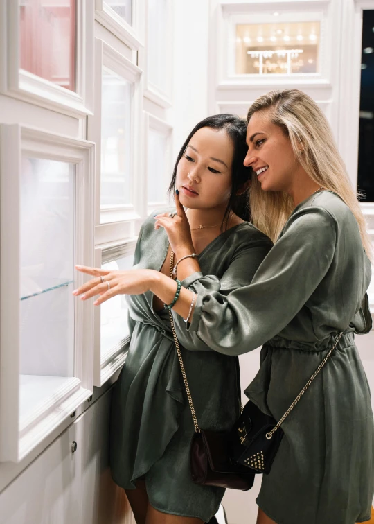 a couple of women standing next to each other, trending on unsplash, luxury item showcase, shopwindows, inspect in inventory image, ruan jia and mandy jurgens