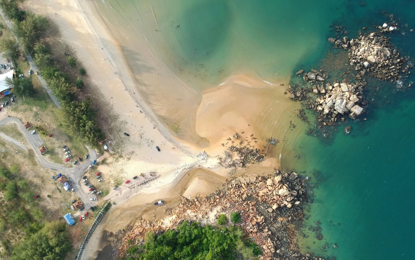 a large body of water next to a sandy beach, by Daniel Lieske, pexels contest winner, airborne view, landslides, thumbnail, manly