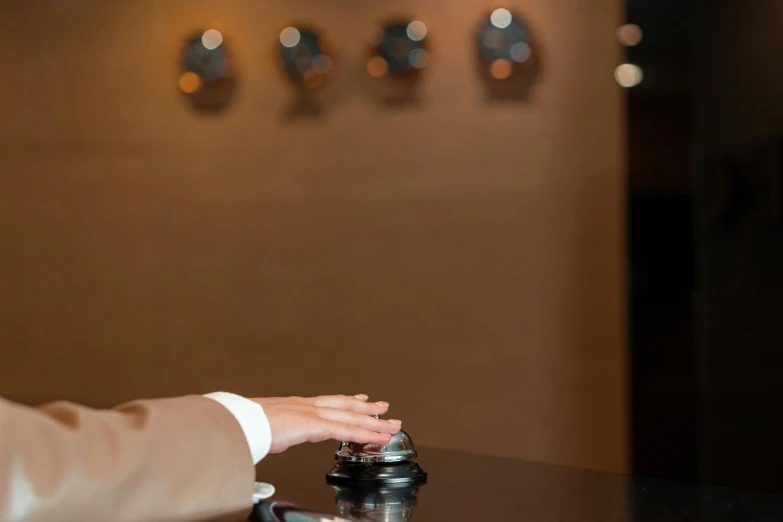 a person putting something in a blender on a counter, by Jay Hambidge, unsplash, happening, hotel room, bells, brown, elegantly dressed