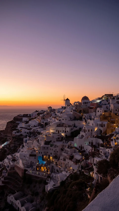 the sun sets over the village of oia on the greek island of santo, by Daniel Seghers, square, high quality photo