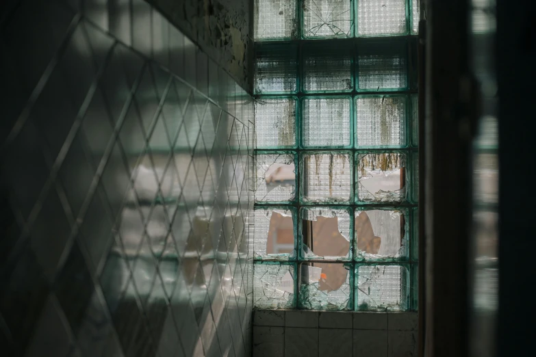 a bathroom with a broken glass window next to a toilet, inspired by Elsa Bleda, unsplash contest winner, arte povera, behind bars, ignant, buildings made out of glass, broken glass photo