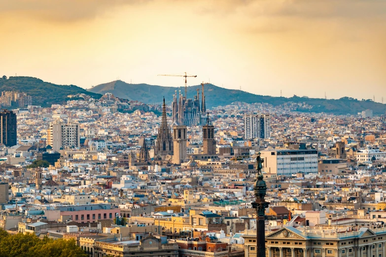 a view of a city from the top of a hill, by Gaudi, pexels contest winner, art nouveau, three views, warm light, a wooden, holy