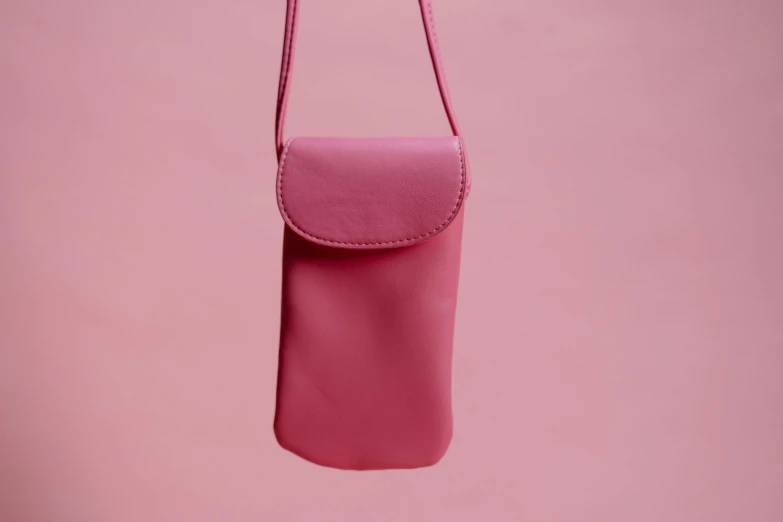 a pink purse hanging on a pink wall, trending on pexels, color field, cellphone, surgical iv bag, red monochrome, navy