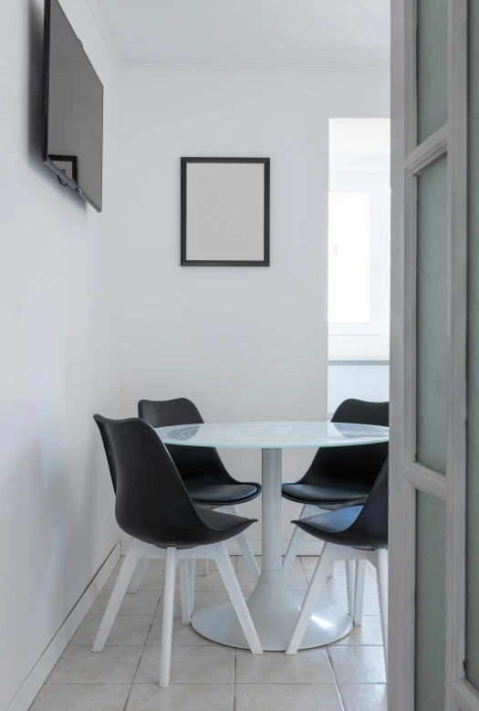 a dining room with a white table and black chairs, pexels contest winner, minimalism, cubical meeting room office, street corner, slate, round format