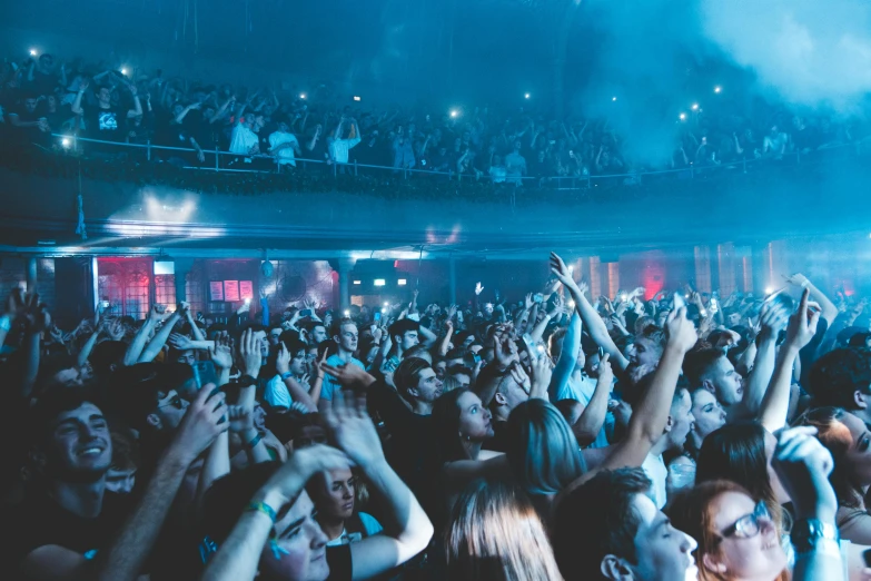 a crowd of people at a concert with their hands in the air, pexels contest winner, happening, hull is a opera house, blue neon, photograph of three ravers, completely empty