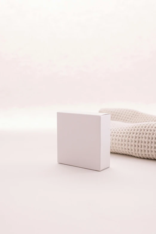 a white box sitting on top of a table, by jeonseok lee, unsplash, minimalism, white soft leather model, packaging, albino, white cyc