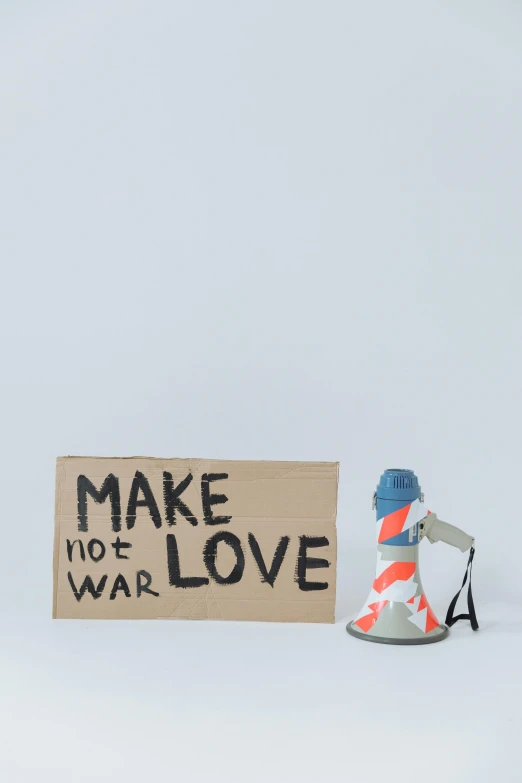 a pair of shoes sitting next to a sign, a statue, inspired by Banksy, graffiti, war photograph, vinyl toy figurine, love craft, set against a white background