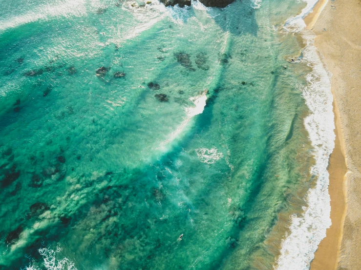 a large body of water next to a sandy beach, pexels contest winner, happening, close-up from above, point break, alana fletcher, vivid and detailed