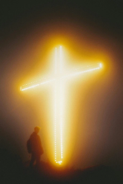 a person standing in front of a glowing cross, a picture, by Thomas Bock, conceptual art, yellow, portra 8 0 0 ”, profile image, : kendrick lamar