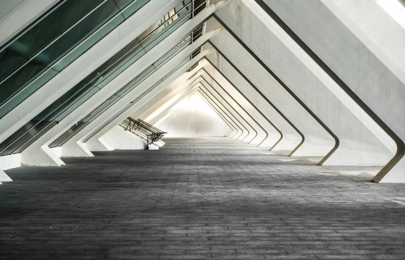 a row of benches sitting inside of a building, inspired by Zaha Hadid, pexels contest winner, light and space, pyramid portal, francis goya, louis kahn, calatrava