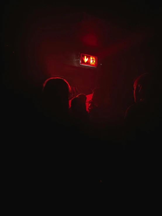 a couple of people that are standing in the dark, red light, foreboding room, dark vibes, dark people discussing