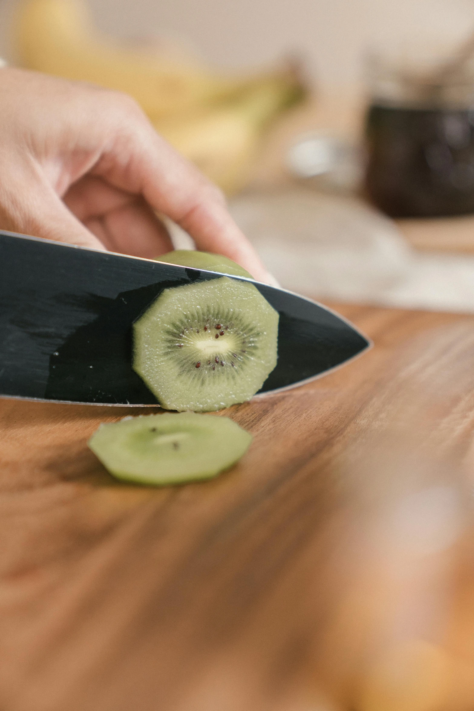 a person cutting a kiwi on a cutting board, a still life, by Matthias Stom, shutterstock contest winner, wielding kunai, on kitchen table, graphic detail, manuka