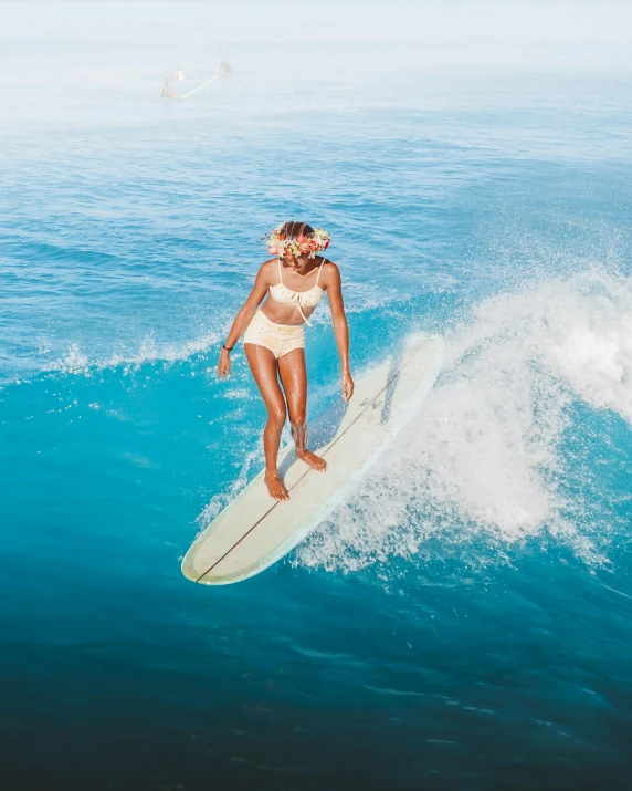 a woman riding a wave on top of a surfboard, slightly tanned, iconic, reefs, tan complexion