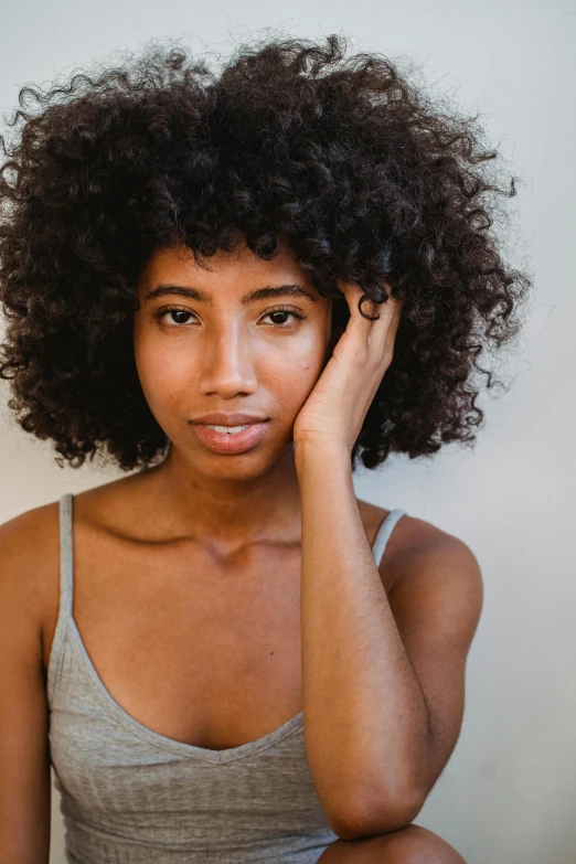 a close up of a person with a curly hair, dramatic bored expression, light-brown skin, confident relaxed pose, thinning hair