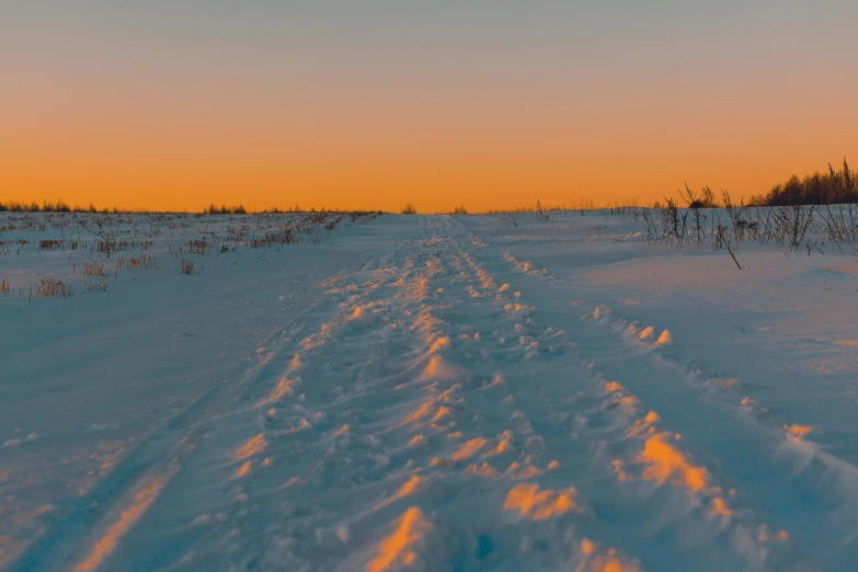 a person riding a snowboard down a snow covered slope, an album cover, by Filip Hodas, pexels contest winner, land art, evening sunset, empty snow field, panorama, today\'s featured photograph 4k