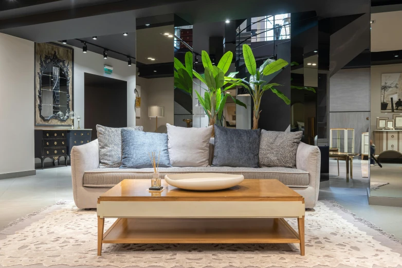 a living room with a couch and a coffee table, inspired by Emilio Grau Sala, pexels contest winner, lacquered oak reception desk, show room scene, thumbnail, flawless completion