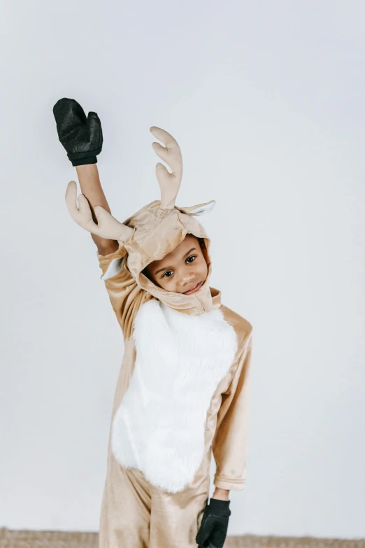 a little boy dressed in a reindeer costume, by Nina Hamnett, pexels contest winner, visual art, holding arms on holsters, kangaroo, neutral pose, diverse