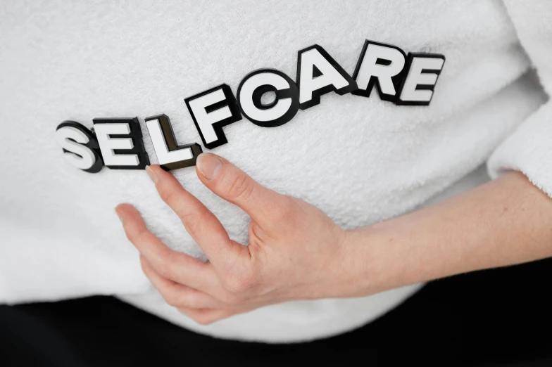 a close up of a person holding a cell phone, a cartoon, inspired by Henri Bellechose, trending on pexels, pregnant belly, hellcore, in white lettering, caretaker