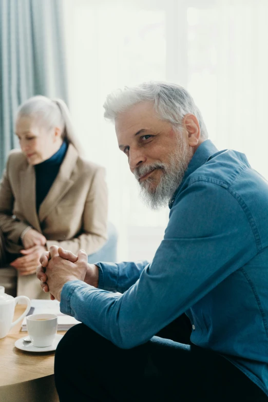 a group of older people sitting around a table, by Adam Marczyński, pexels, renaissance, some grey hair in beard, man and woman walking together, pondering, medium shot of two characters