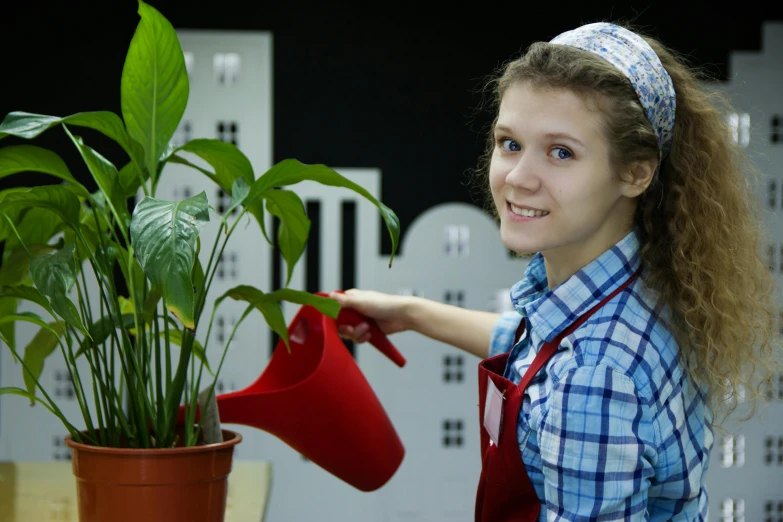 a woman watering a potted plant on a table, pexels contest winner, hurufiyya, avatar image, girl wearing uniform, plumbing jungle, high resolution photo