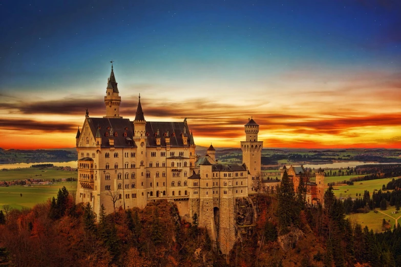 a castle sitting on top of a lush green hillside, pexels contest winner, german romanticism, at sunset in autumn, stunning grand architecture, nighttime, fairytale style