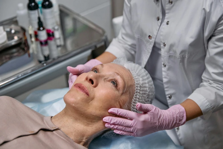 a woman getting a facial lift in a beauty salon, a photo, by Adam Marczyński, shutterstock, renaissance, older woman, cysts, coerent face and body, manuka