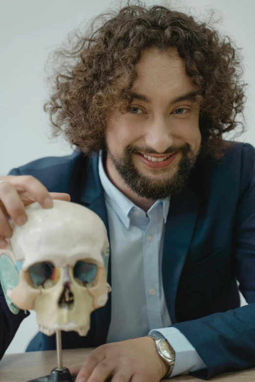 a man sitting at a table with a skull in front of him, featured on reddit, vanitas, sam hyde, showcases full of embryos, ai researcher, kramskoi 4 k