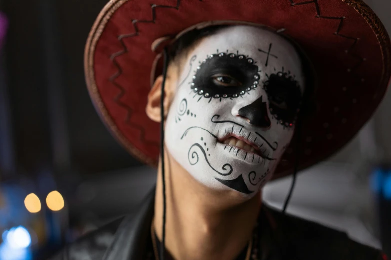 a close up of a person wearing a hat, pexels contest winner, lowbrow, skull face paint, young spanish man, square, ( ( ( skeleton ) ) )