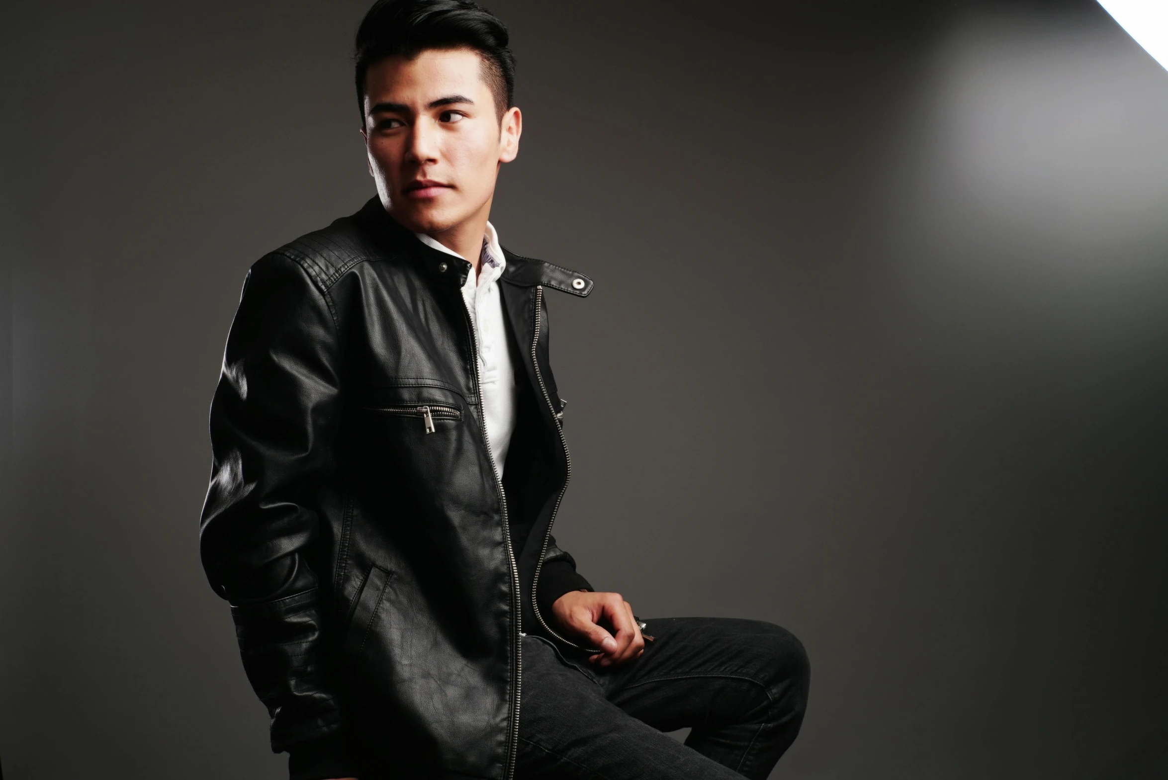 a man in a leather jacket sitting on a stool, an album cover, inspired by Huang Gongwang, pexels, well-groomed model, profile image, confident pose, rectangle