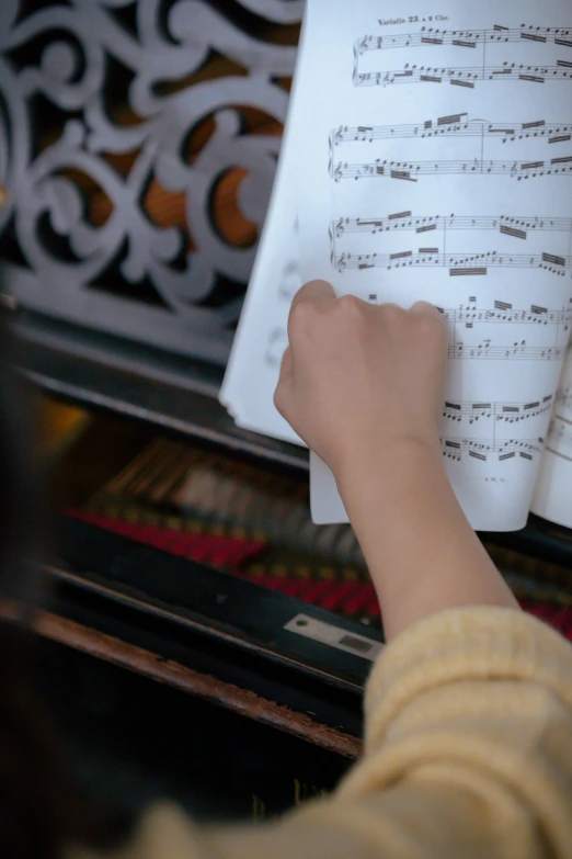 a close up of a person playing a piano, standing on top of a piano, sheet music, schools, panels