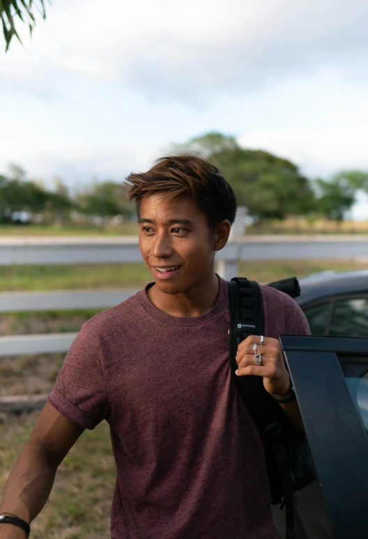 a man that is standing next to a car, by Reuben Tam, with a backpack, headshot profile picture, slightly tanned, big island