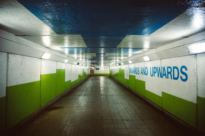 a long hallway with green and white walls, inspired by Thomas Struth, unsplash contest winner, graffiti, london underground tube station, blue and yellow lighting, freeway, travel upwards