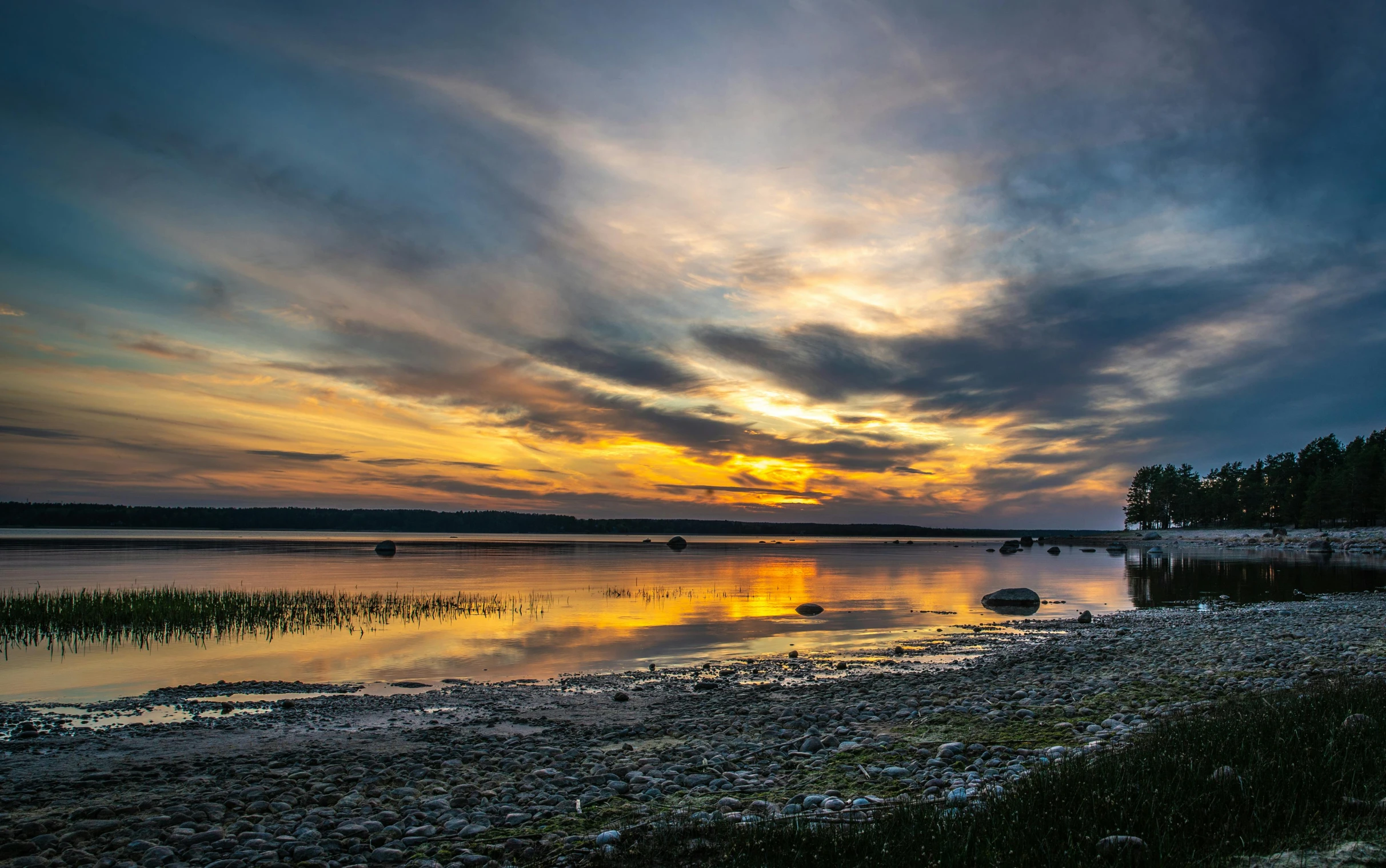 a large body of water next to a forest, by Jan Tengnagel, pexels contest winner, sunset panorama, pembrokeshire, fan favorite, ultrawide image