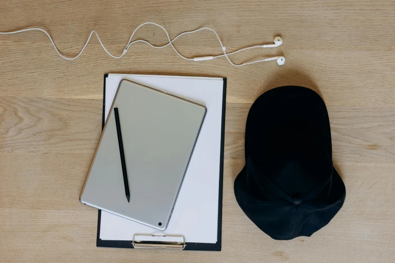 a laptop computer sitting on top of a wooden table, an album cover, unsplash, baggy clothing and hat, draw with wacom tablet, minimalissimo, no - text no - logo