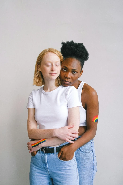 a couple of women standing next to each other, trending on pexels, lesbian embrace, with a white complexion, coloured, pale