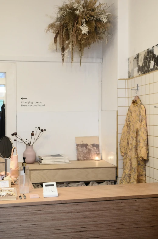 a bath room with a sink and a mirror, by Caro Niederer, unsplash, happening, shop front, roots and hay coat, gallery display photograph, beige and gold tones