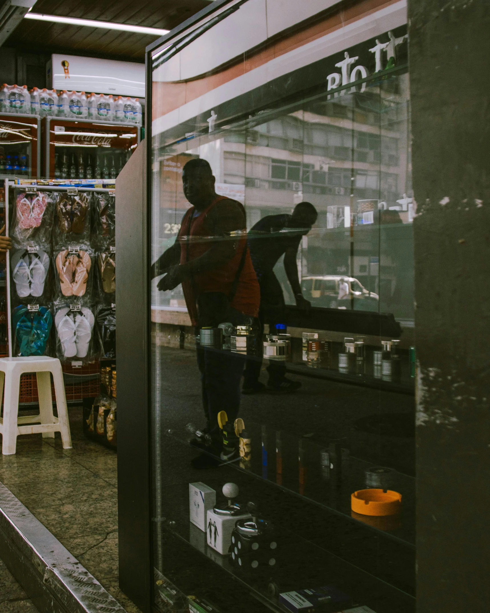 a person standing in front of a vending machine, by Elsa Bleda, pexels contest winner, mirror and glass surfaces, black man, in sao paulo, exiting store