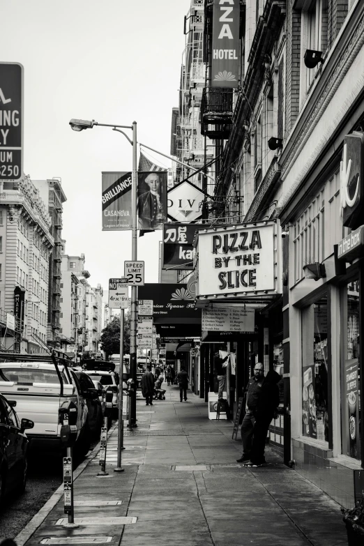 a black and white photo of a city street, by Bernie D’Andrea, pexels contest winner, harlem renaissance, pizza, bay area, signs, side