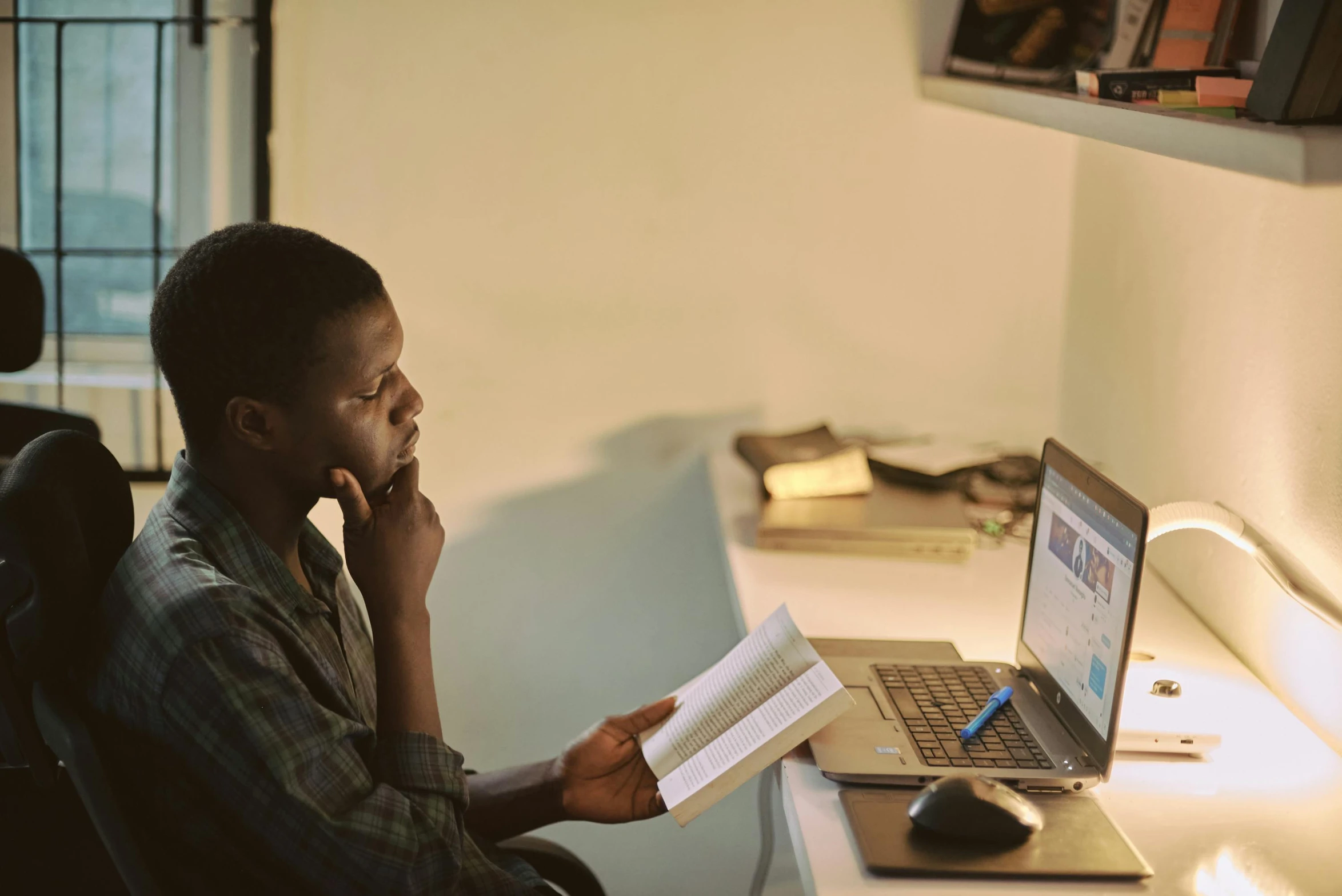 a man sitting at a desk in front of a laptop computer, by Carey Morris, pexels contest winner, academic art, emmanuel shiru, trying to read, official screenshot, ignant