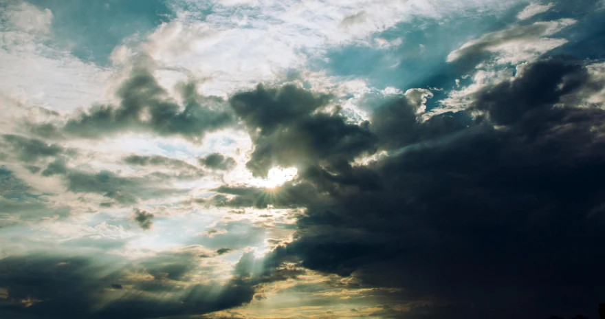 a person flying a kite under a cloudy sky, pexels contest winner, light and space, crepuscular rays, thunderclouds, instagram post, god rays volume light