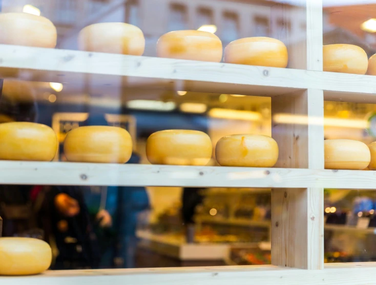 a store window filled with lots of cheese, by Julia Pishtar, fan favorite, round windows, recipe