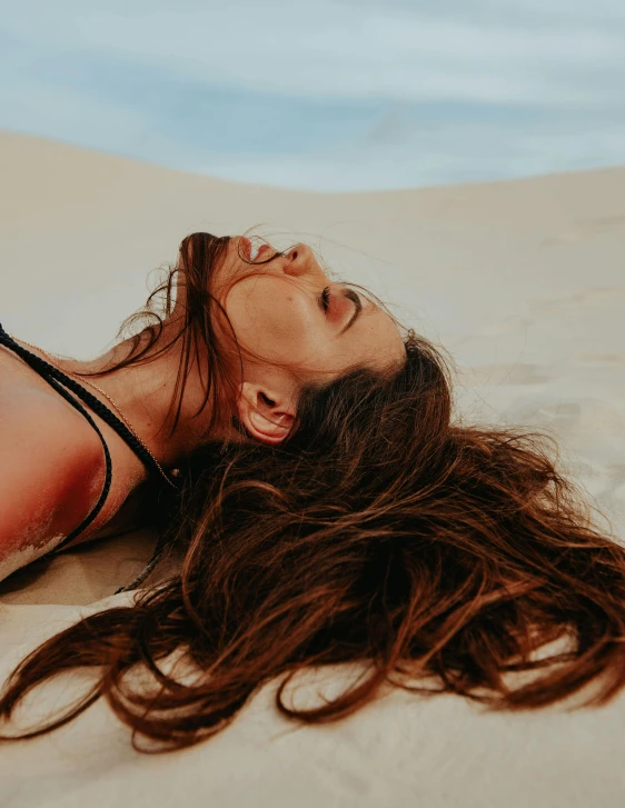 a woman laying on top of a sandy beach, trending on pexels, with textured hair and skin, gif, sexy :8, happy vibes