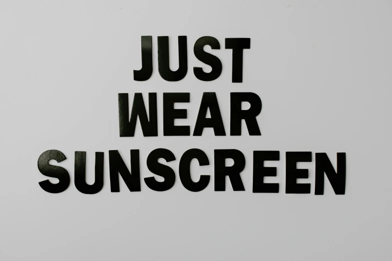 a black and white sign that says just wear sunscreen, in the style of john baldessari, laser cut, translucent, 3 4 5 3 1