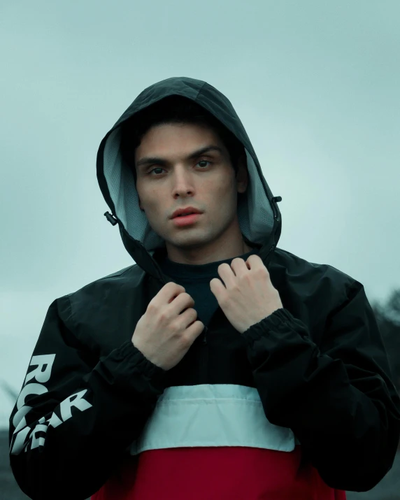 a man in a hoodie poses for a picture, an album cover, by Attila Meszlenyi, unsplash, realism, non binary model, moncler jacket, trending on r/streetwear, smirking deviously