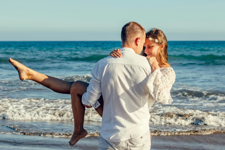 a man carrying a woman on his back at the beach, pexels contest winner, romantic themed, white, thumbnail, blue