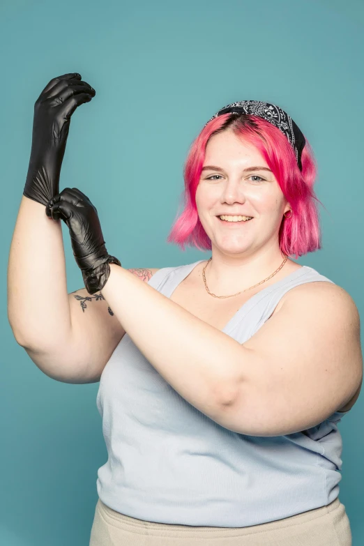 a woman with pink hair wearing black gloves, featured on reddit, proportionally enormous arms, non-binary, promo photo, surgery